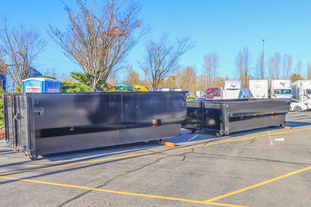 Professional dumpster rental service with roll-off container on residential driveway in Fairburn